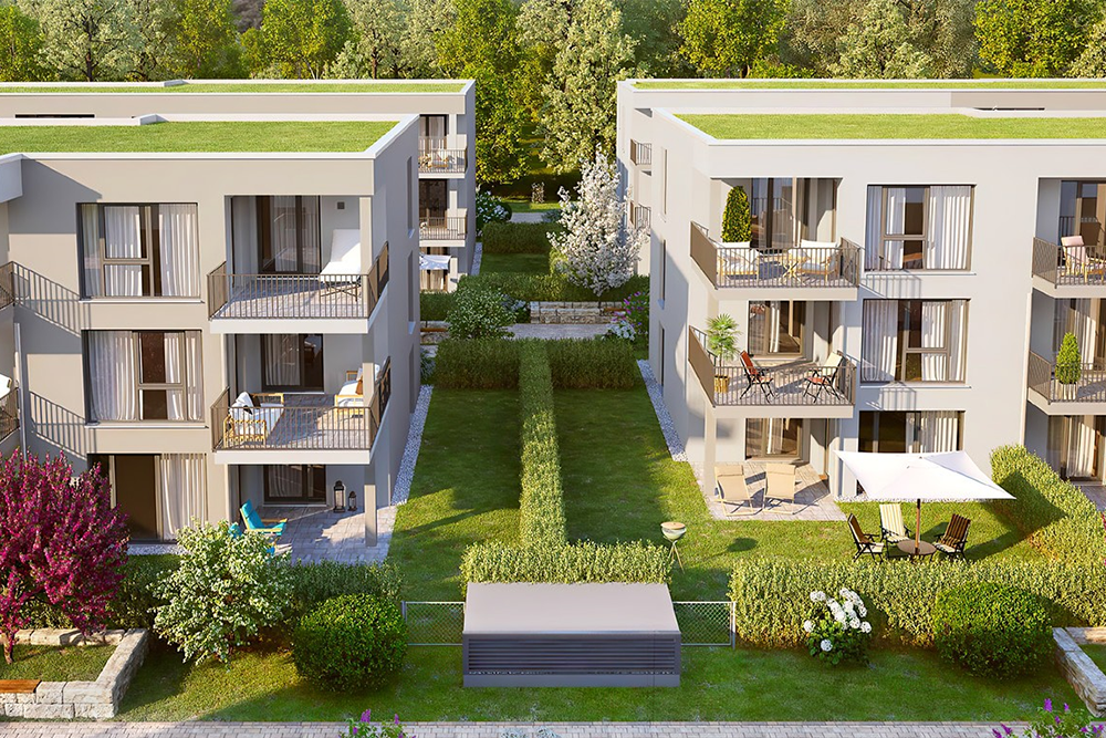 Zwei Mehrfamilienhäuser in einem Neubaugebiet mit grünem Umfeld